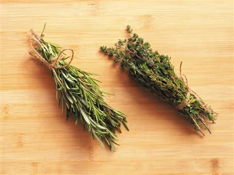 Premium Photo | Rosemary and thyme on a wooden board view from above