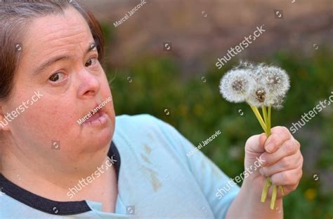 down syndrome woman blowing dandelion People Images | Creative Market