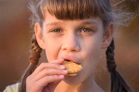 Little Girl Enjoying Cookies With A Smile At Sunset A Closeup Photo Background And Picture For ...