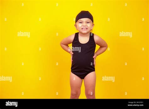 Little girl wearing beach outfit on yellow background. Summer and ...