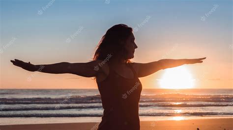 Premium Photo | Silhouette of woman on the beach in yoga position