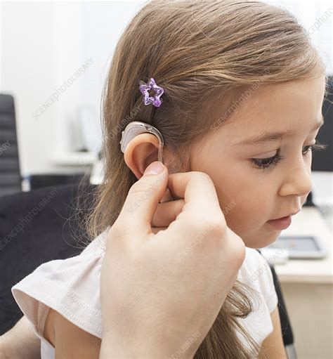 Hearing aid fitting - Stock Image - F036/3196 - Science Photo Library