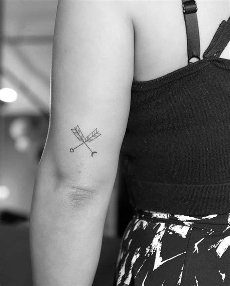 Crossed arrows done at Fine Line Tattoo - Tattoogrid.net