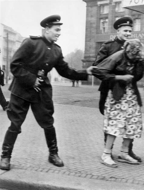 Soviet soldiers openly sexually harass a German woman in Leipzig, 1945 ...