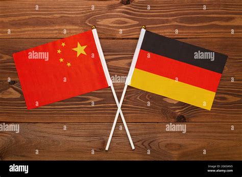 Flag of China and flag of Germany crossed with each other. The image illustrates the ...