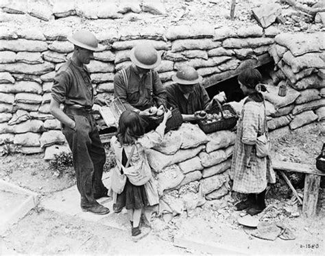 Canadian soldiers buying fruit from two little French girl… | Flickr