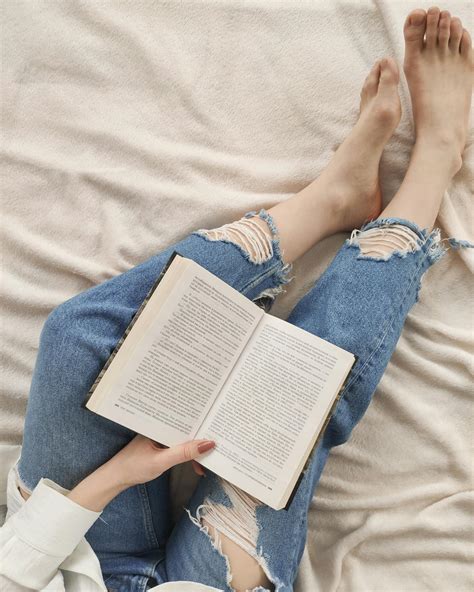 Crop unrecognizable woman reading book on comfy bed · Free Stock Photo