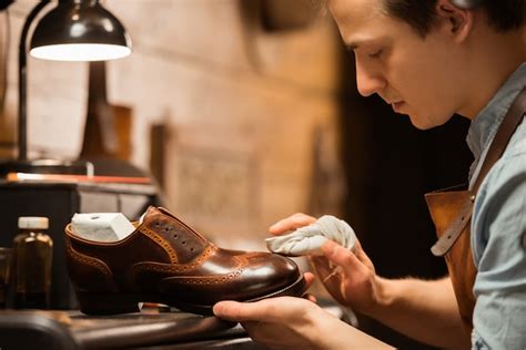 Free Photo | Concentrated shoemaker in workshop making shoes