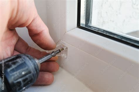 Installing wooden blinds. Stock Photo | Adobe Stock