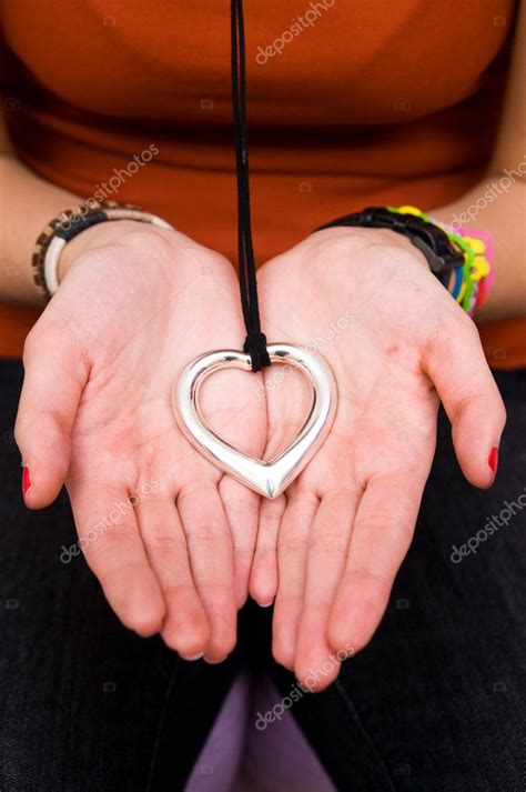 Young female holding a heart shaped necklace in her hands — Stock Photo © drkskmn #8105047