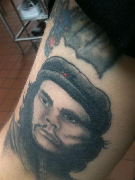 a man's leg with a tattoo on it that has a portrait of a man