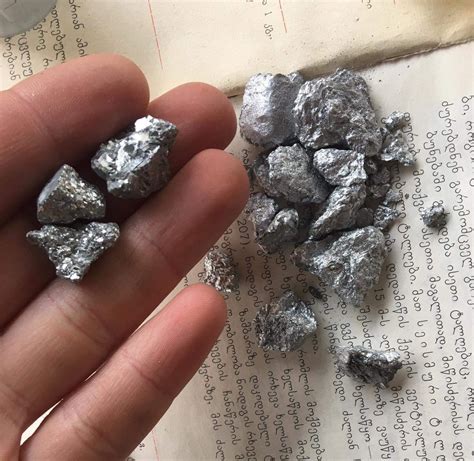 Antimony (in hand) and very old and toxic paint which looks like antimony. : r/chemistry