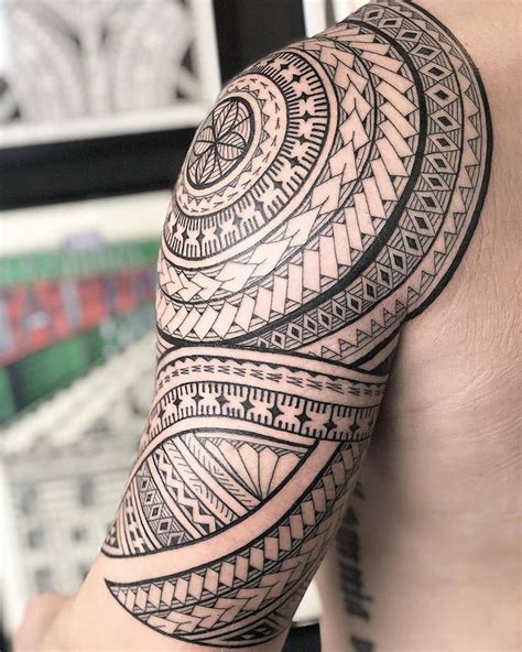 a man's arm with an intricate tattoo design on it