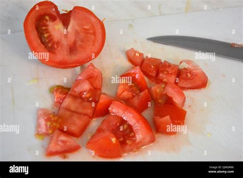 Healthy food, vegetables, large red tomatoes cut into slices or covered ...