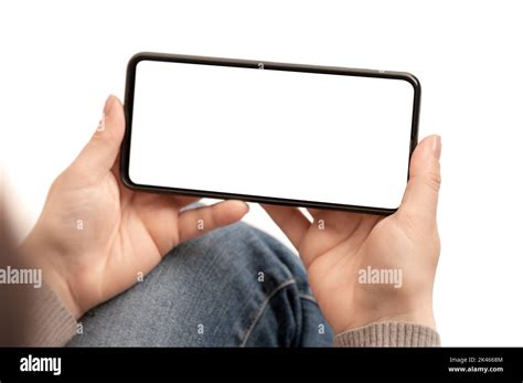 horizontal cell phone mockup. woman watching video on cell phone mockup sitting on white ...