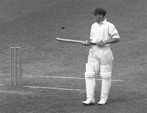 Don Bradman bounces the ball on his bat during a lull in his first-day ...