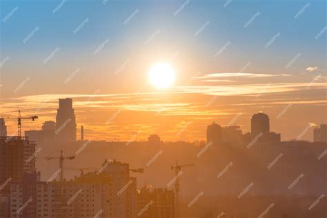 Premium Photo | Panoramic view of sunset in the city with silhouette of buildings and industrial ...