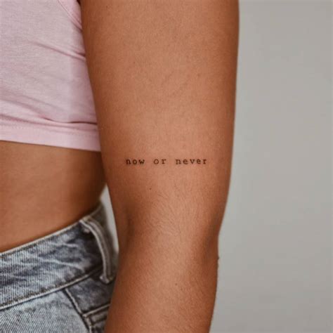 Tattoo that says "now or never" located on the upper