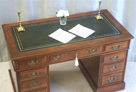 A small antique pedestal desk with an excellent new green leather top ...