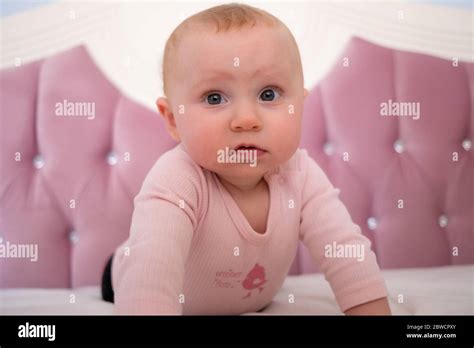Cute baby girl standing on bed make funny faces, angry face, crying in the morning Stock Photo ...