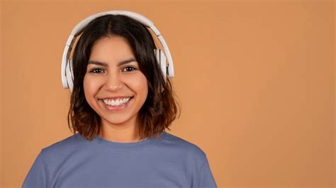 Premium Photo | Closeup of middle eastern lady using wireless headphones