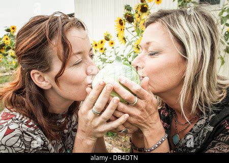 Abigail Sullivan and Kasha Rigby with some vegitables from their garden in Boulder, Utah Stock ...