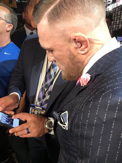 Conor McGregor with a cynical pinstriped suit