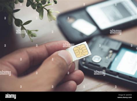 SIM card for smart phone. Changing the SIM card Stock Photo - Alamy