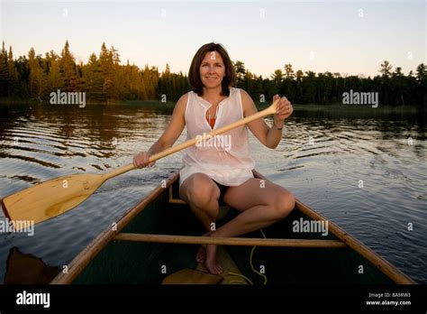 Woman canoeing Stock Photo - Alamy