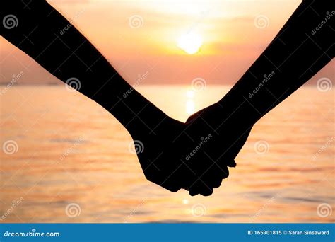 Silhouette Couple Hold Hands Look At Each Other Stock Photo | CartoonDealer.com #44406402