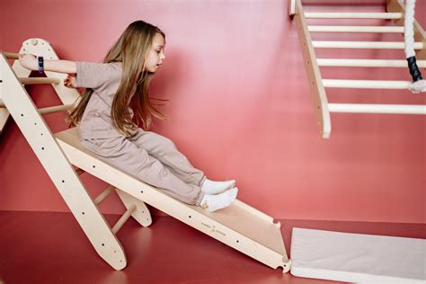 Girl on a Wooden Home Playground Slide · Free Stock Photo