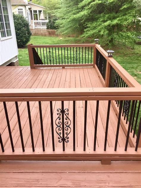 a wooden deck with wrought iron railings