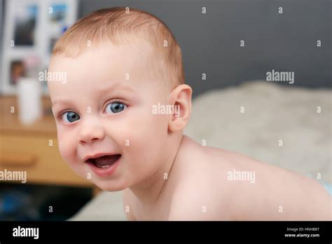 Baby boy with large blue eyes looking into camera Stock Photo - Alamy