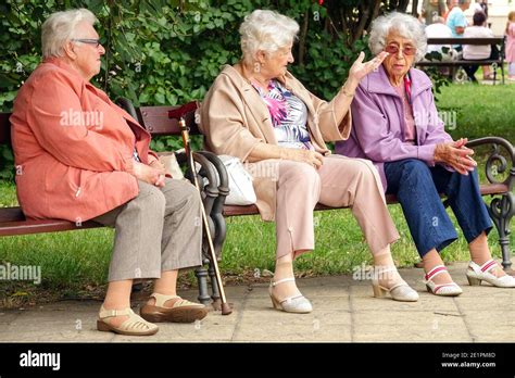 Three elderly women sitting on a bench in city park Seniors aging, Old women bench, old people ...