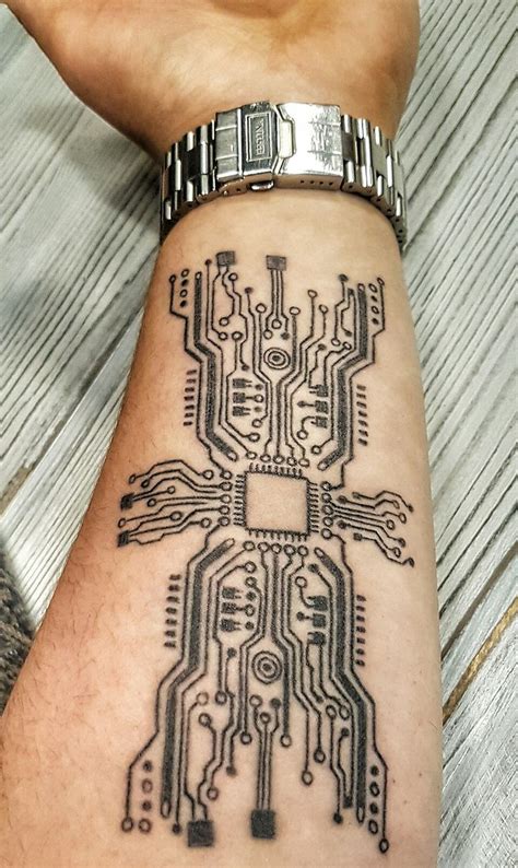 a person's arm with a tattoo on it that has an electronic circuit board design