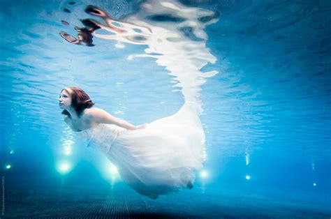 "Trash The Dress Underwater Bride Swimming In Wedding Dress To Surface" by Stocksy Contributor ...