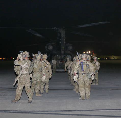 Rangers of 3rd Battalion, 75th Ranger Regiment, board their aircraft to go into the night and ...