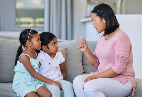 Premium Photo | Being a parent can be frustrating. shot of a woman scolding her two daughters.