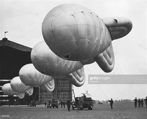 News Photo : Barrage balloons lined outside their hangar at ...