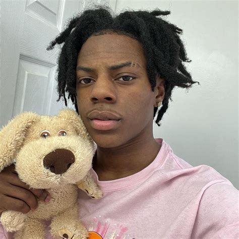 a man with dreadlocks holding a stuffed dog in front of his face and ...