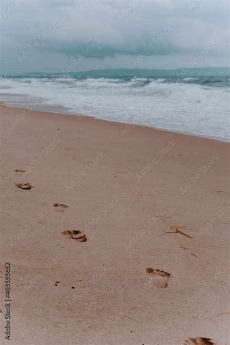 footprints in the sand. beach, wave and footprints on a sandy beach ...