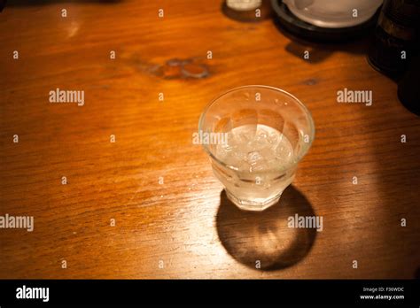 Glass of ice water on wooden table Stock Photo - Alamy