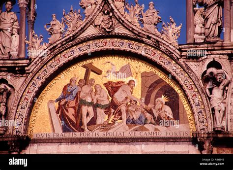 Brightly lit gold artwork on facade of Basilica San Marco Piazza san Marco St Marks Square ...