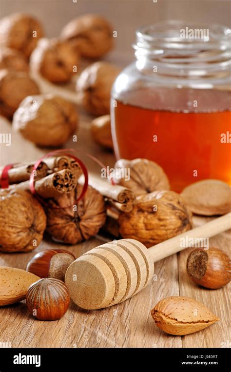 nuts walnuts almonds tonsils honey glass chalice tumbler sticks nuts festive Stock Photo - Alamy