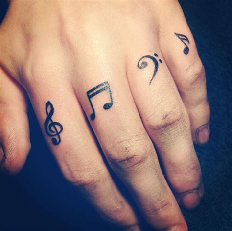 Music symbols tattoo on fingers