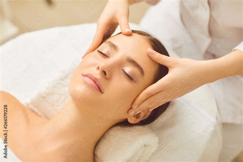 Beautiful girl has a facial massage in a beauty clinic. Stock Photo | Adobe Stock