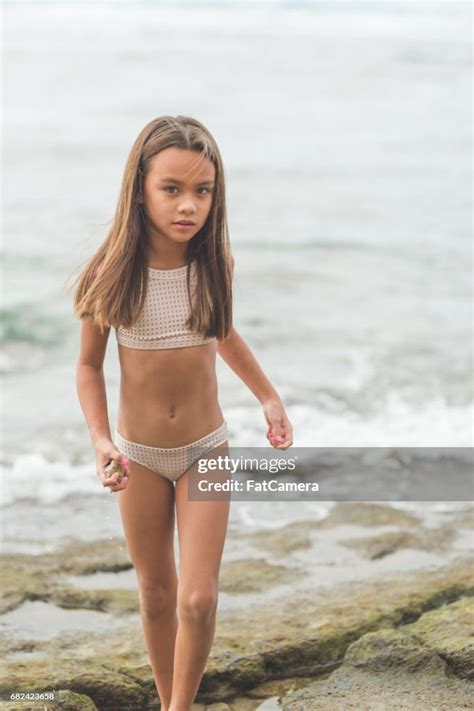 Ethnic Girl In Swimsuit Walks Along Hawaii Beach High-Res Stock Photo ...