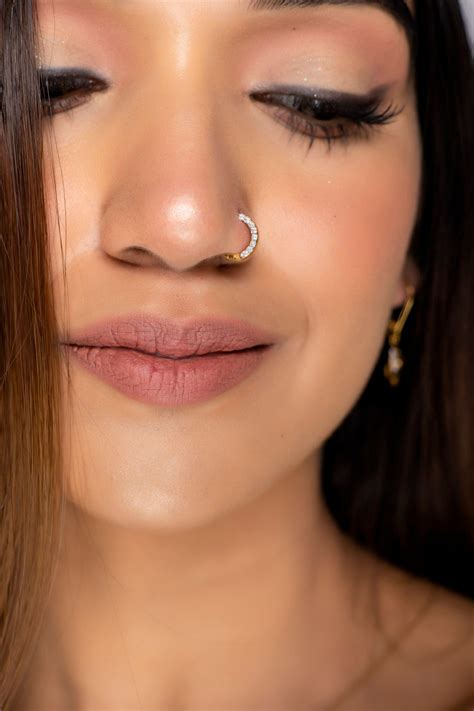 "This nose ring has diamonds studded on it on its sides and thus when you wear this, this ...