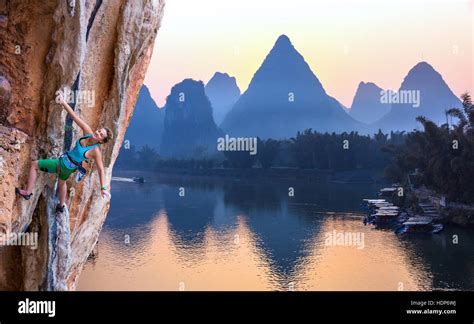 Bright Image of Young Rock Climber Sunrise karst Mountains in China and River Stock Photo - Alamy