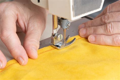 Hands of Seamstress Sewing with a Professional Machine, Embroiders Sews on Grey Fabric Stock ...